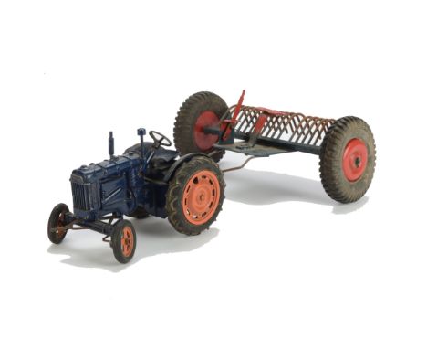 A Chad Valley Fordson Tractor and Rake, in blue, G, clockwork requires attention, rear hook secured with wire, over-scale met