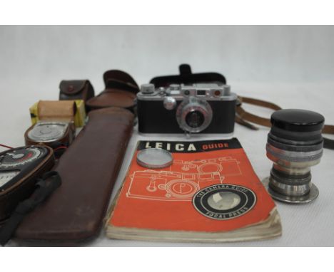 A Leica DRP Ernst Leitz Wetzlar No 256888 with guidebook and accessories to inc a lense by Taylor Hobson No 176357