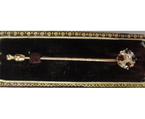 A gold, ruby and diamont diamond tie pin