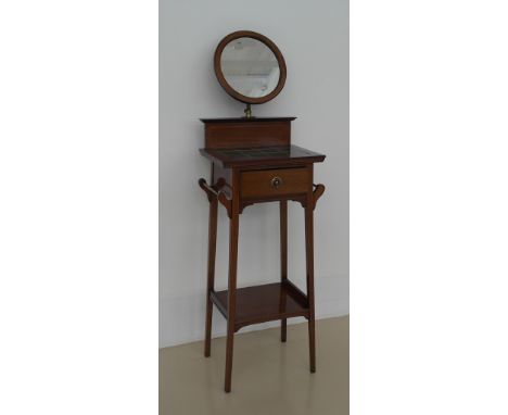 An Edwardian mahogany tile-topped shaving stand with mirror to back
