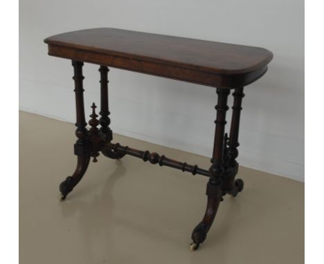 A 19th century mahogany side table on ceramic castors