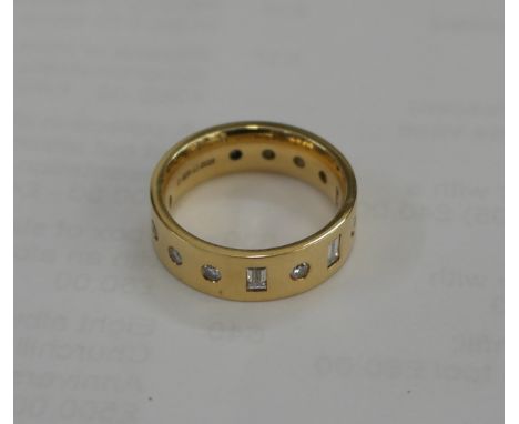An 18ct diamond band ring set with brilliant cut and baguette diamonds