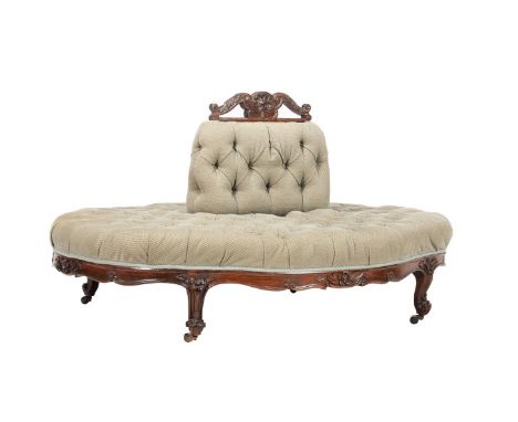 A VICTORIAN WALNUT AND UPHOLSTERED CONVERSATION SOFA OF OVULAR FORMCIRCA 1860The central bolster with a scroll-carved top abo
