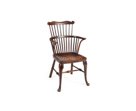 AN ASH AND ELM WINDSOR ARMCHAIR 19TH CENTURYThe comb back above a solid seat and cabriole legs to the front92cm high Conditio