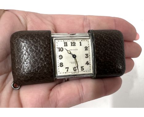 Movado, a chronometer Ermeto travelling clock, set in silver, number 1217817, to a sliding outer case.