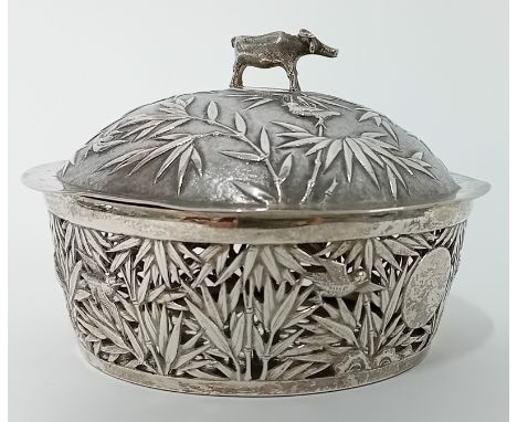 A Chinese silver lidded Butter Dish and Stand decorated with bamboos in relief to lid with ‘cow’ finial, the dish and stand p