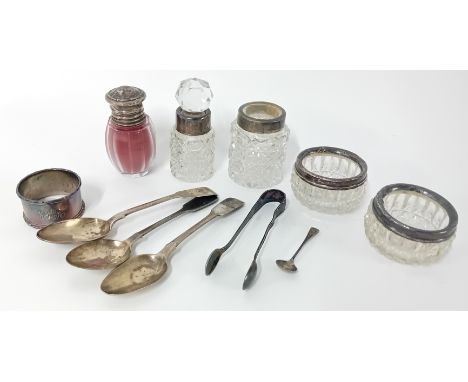 A collection of silver items, to include three teaspoons, sugar tongs, mounted table salts and scent bottles, and a napkin ri