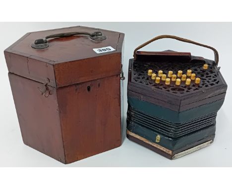 A 19th century concertina by J. Wallis, patent, of London, pierced fret work sides, in a fitted hexagonal box.