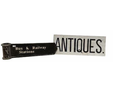 Cast metal 'Bus &amp; Railway stations' sign, together with a sign reading 'Antiques'
