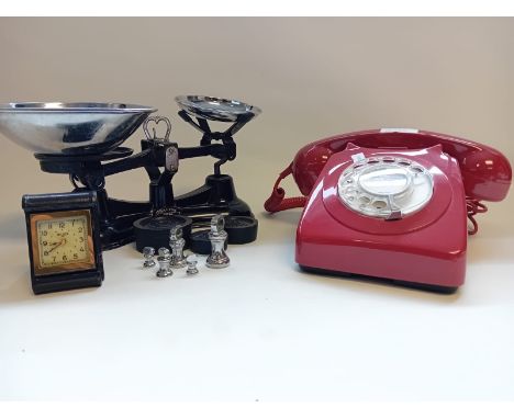 Vintage red dial up phone, weighing scales with weights and a small vintage travel clock