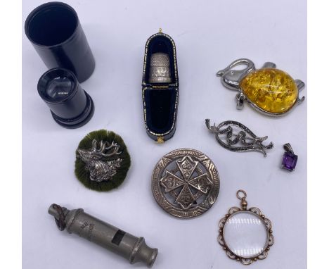 Lot of items to include silver thimble in vintage fitted case collection of broaches with a 9ct gold glass pendent (combined 