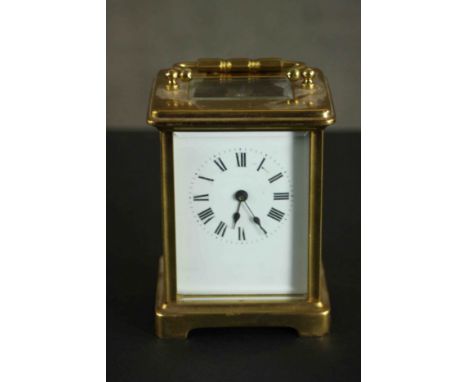 A 19th century gilt brass and plate carriage clock with white enamel dial and black Roman numerals. With key.  H.11 W.8 D.7cm