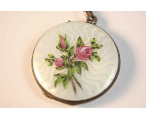 An early 20th century Continental silver enamelled circular locket, white guilloche enamel with a central hand painted rose b