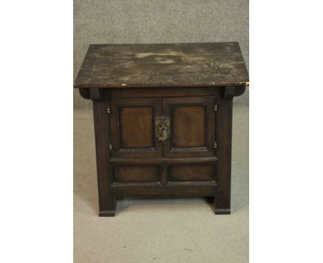 A C.1900 Korean elm table top cabinet with panel doors on block feet. H.61 W.67 D.55cm.