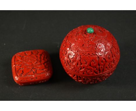 Two 20th century Chinese carved cinnabar lacquer boxes, one of spherical form with dragon and cloud design and a jade bead ha