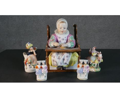 A collection of 19th century Staffordshire pottery figures. A pair of flat back figures of a couple (head repaired), a lady r