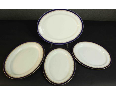 Four Royal Worcester vitreous gilt and royal blue design oval ceramic serving platters. Maker's marks to base. L.36 W.28cm. 