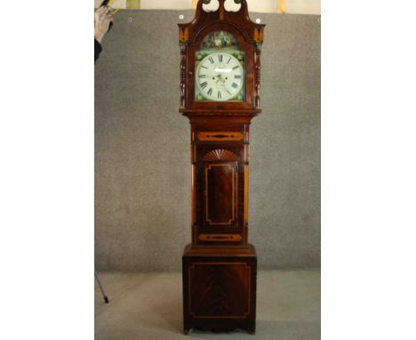 A George III Sheraton style flame mahogany and satinwood inalaid longcase clock, the hood with a swan neck pediment and brass