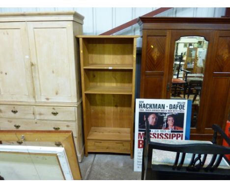 A light oak bookcase fitted single drawer below