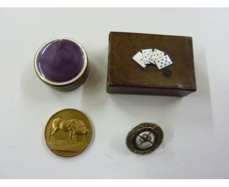 A tray containing a brass and enamel pill box; a Royal Life Society saving badge and a horse related medallion in an enamel d