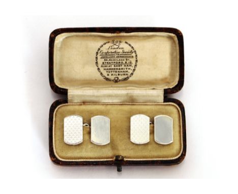 A pair of silver engine turned cufflinks