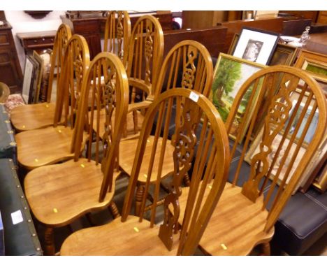 A set of eight stick and wheel back dining chairs to include two carvers