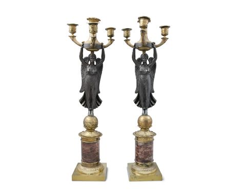 A PAIR OF FRENCH EMPIRE ORMOLU AND MARBLE FIGURAL CANDELABRA, modelled with a winged victory holding aloft a four light torch