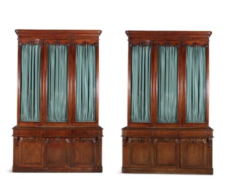 A PAIR OF VICTORIAN THREE DOOR MAHOGANY BOOKCASES, C.1850,&nbsp; the upper sections with glazed panel doors and pleated curta