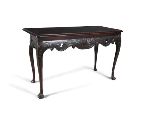 AN IRISH CARVED MAHOGANY CONSOLE TABLE, MID-18TH CENTURY, the deep frieze centred by a shell and flanked by pierced scrolls, 