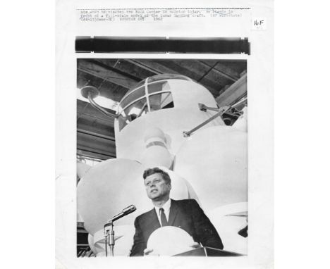 President John F. Kennedy with a scale model of the Apollo command module at the Rich Building of the Manned Spacecraft Cente