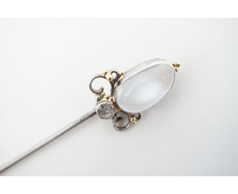 A Belle Epoque moonstone and white sapphire stick pin, of organic form, with moonstone cabochon of approximately 12 x 7 mm, b