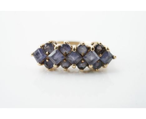 A vintage amethyst cocktail ring, pellet set in three parallel lines of alternating round- and princess-cut amethysts, on a 9