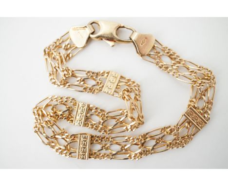 A 9ct gold delicate gate-link style bracelet, comprising three adjacent rows of Figaro and curb-links faced by four rectangul