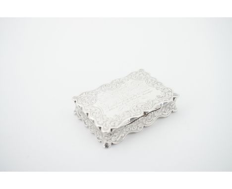 A Victorian silver snuff box by Nathaniel Mills, of shaped rectangular section, with engraved scrolling foliage to the back, 