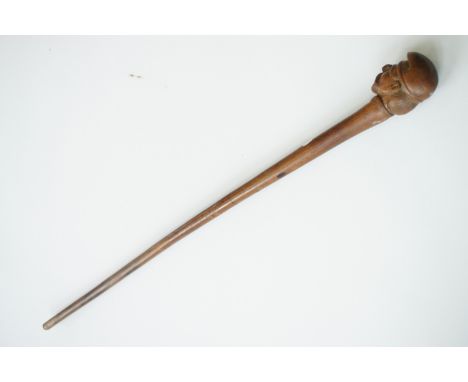 An antique rustic carved fruit wood walking stick, the pommel in the form of the bust of a bearded man wearing a Phrygian cap