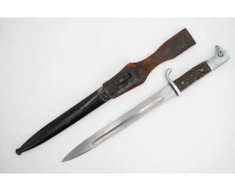 A German Third Reich KS98 dress bayonet, a variant having simulated stag horn grip scales, the blade un-marked, with frog