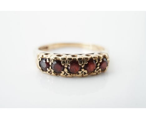 A vintage five-stone garnet dress ring, the largest garnet of approximately .13ct, claw and pellet set on a 9ct gold shank, P