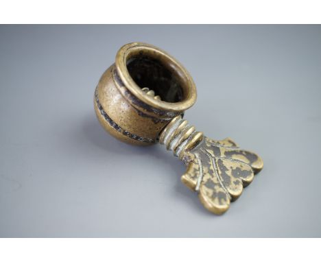 A late 17th / early 18th Century brass pocket nutcracker, bearing engraved initials 'R H', 5.5 cm (including key)