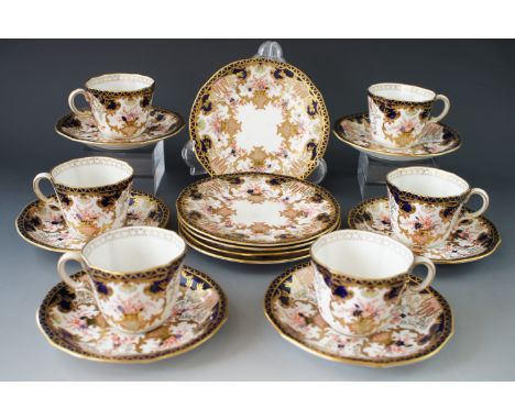 A Royal Crown Derby tea / coffee set, comprising six cups, six saucers, and six cake plates, decorated in an Imari palette wi