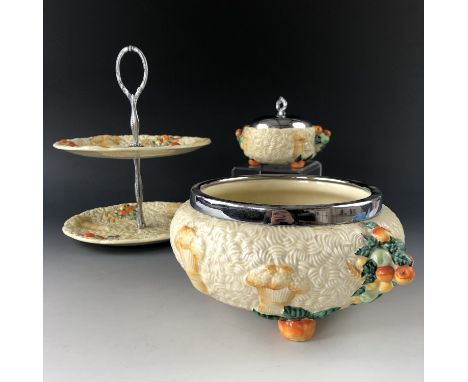 Three items of Newport Pottery Clarice Cliff "Celtic Harvest" pattern wares, including a cake stand, a preserve pot and a bow