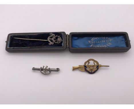 A Seaforth Highlanders silver sweetheart brooch, stick pin and one other brooch modelled as a Lee Enfield rifle 