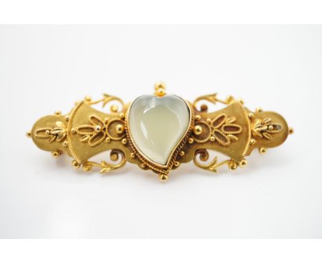 A late Victorian 9ct gold and jade bar brooch, the jade being cut and polished in the form of a heart, bezel-set to the centr