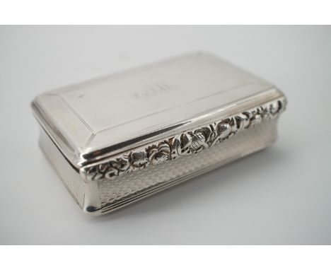 A George III silver snuff box, of rectangular section, with foliate moulded thumb-piece and engine-turned decoration to the c