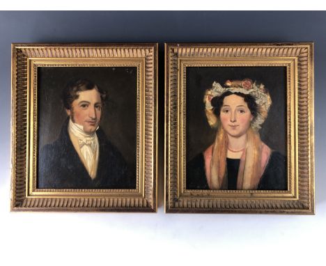 (19th Century) An 1830s head and shoulders portrait pair of a young lady and gentleman, the lady in ruffled lace bonnet adorn