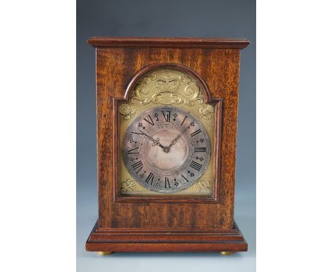 An Elizabeth II Silver Jubilee commemorative mantel clock by Charles Frodsham, having a gilt face with spandrels representing