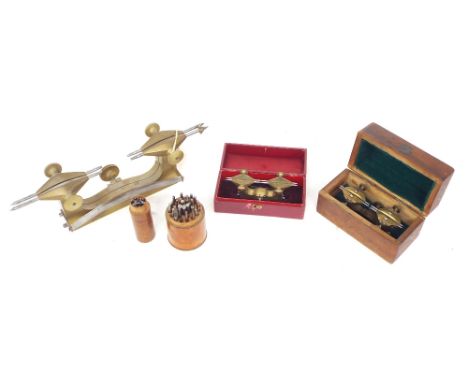 Large brass depthing tool, 7" wide; also two small cased depthing tools and two cylindrical cased staking sets (5)