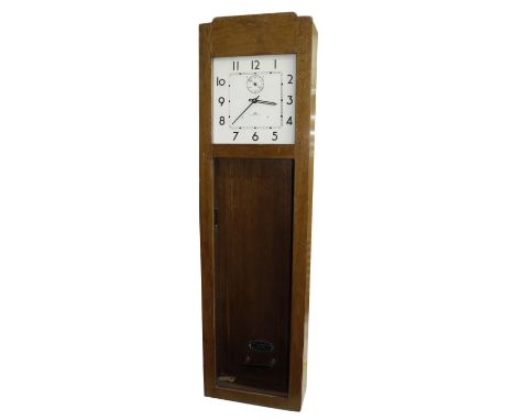 IBM International electric master clock, the 13.75" square white dial with subsidiary seconds dial, within a light oak glazed