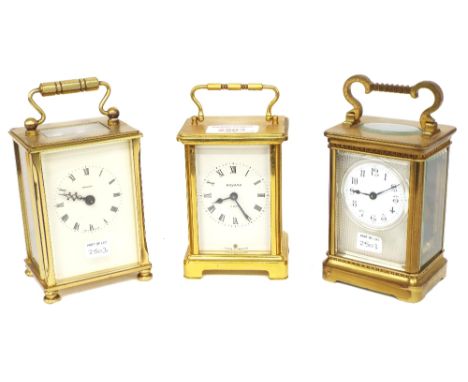 Carriage clock timepiece, the 1.75" white dial within a silvered engine turned mask and corniche style brass case, 6" high; a