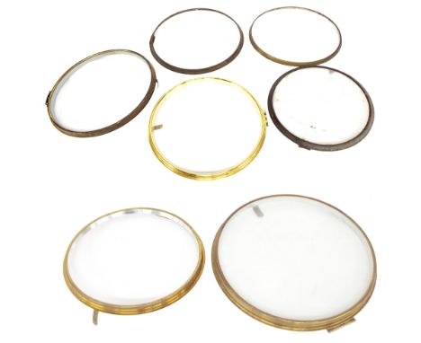 Seven brass dial clock bezels, five x 12", one x 14" and one x 10", four with dial glass (7)