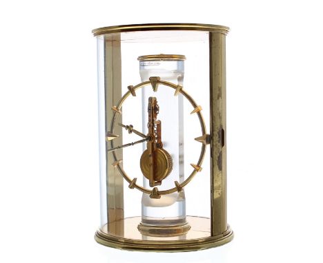 Jaeger-LeCoultre skeleton clock, the 3.5" dial upon a frosted glass pillar and within a cylindrical brass bound case, 7" high